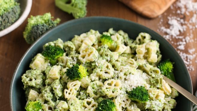 Close up of Creamy Broccoli Pasta in Bowl with ingredients around
