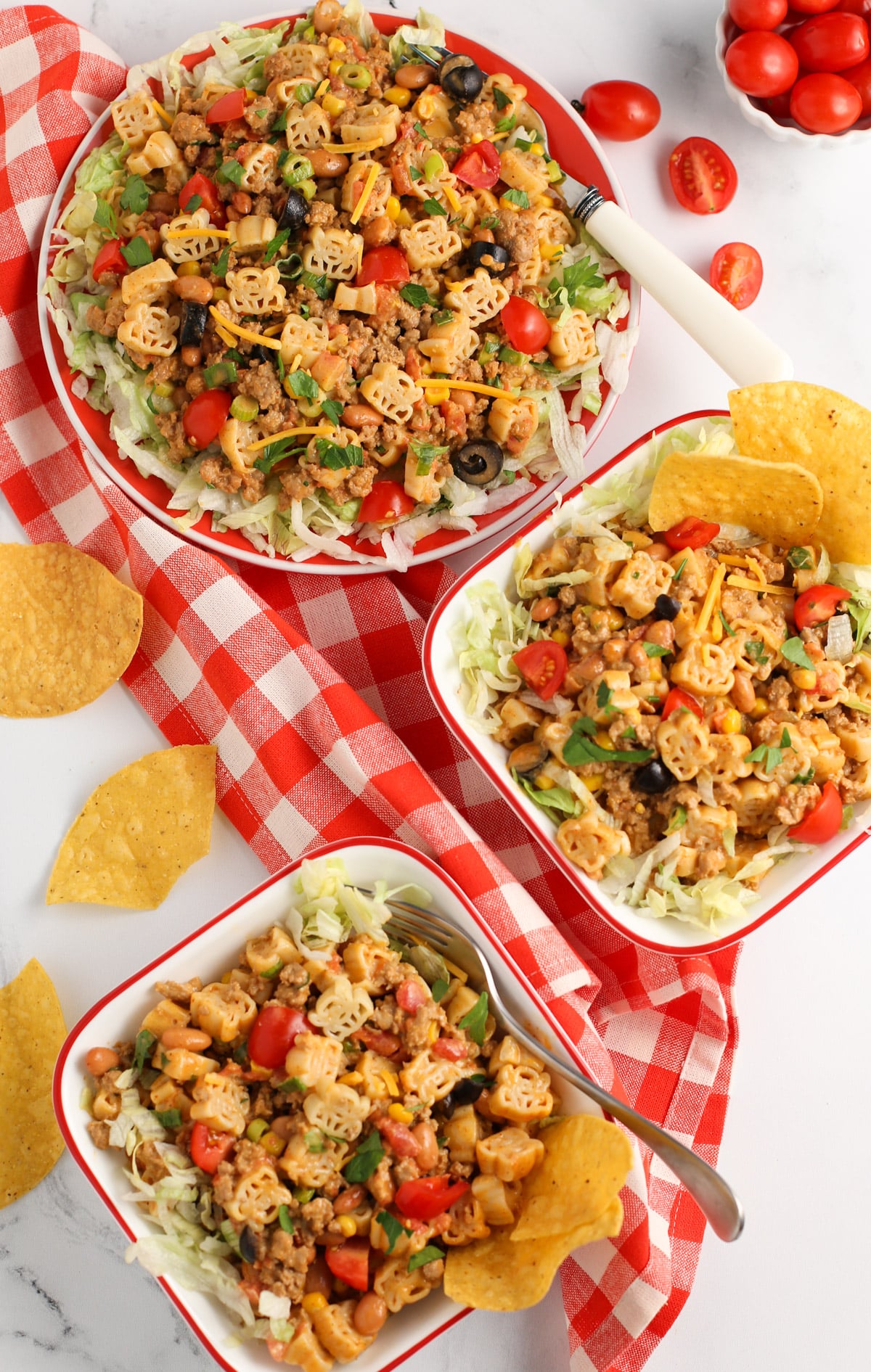 Large serving bowl of Turkey Taco Pasta with two small pasta bowls