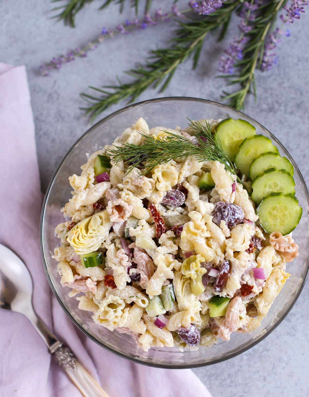 Tzatziki Pasta Salad | Cool and tangy Tzatziki Pasta Salad is the perfect side for a hot summer night! Artichokes, sun dried tomatoes, Kalamata olives, and crunchy cucumbers add just the right Greek flavors. Yum! Serve with grilled meats or chicken! Enjoy! | WorldofPastabilities.com
