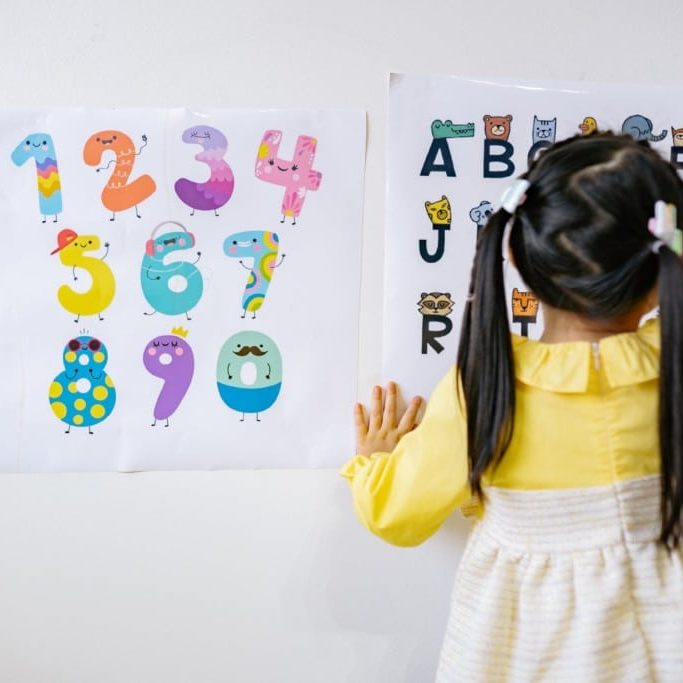 young girl learning her letters and numbers