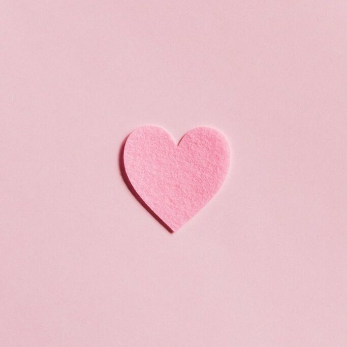 felt heart on pink background