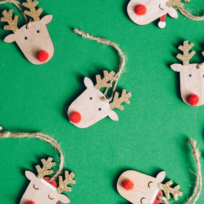 wooden reindeer ornaments on green background
