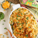 Chicken Noodle Casserole presented in a large ceramic dish with ingredients sprinkled around.