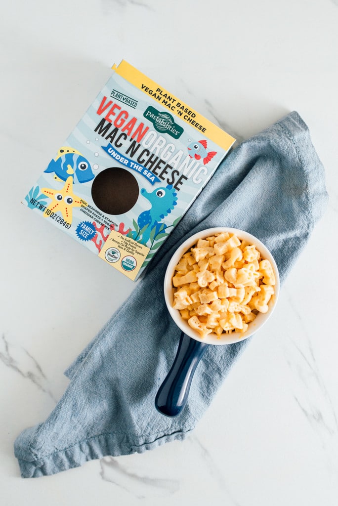 fun pasta mac and cheese vegan on a white marble table with blue napkin for kids