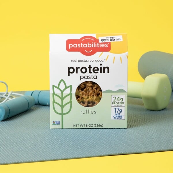 protein pasta on yoga mat with weights and jump rope