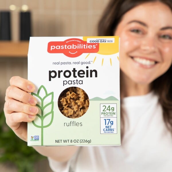 girl holding protein pasta box